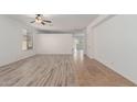 Bright living room featuring wood-look tile flooring and natural light at 43945 W Juniper Ave, Maricopa, AZ 85138