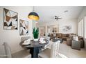 Open-concept dining room with a modern light fixture and a view into the living room at 4831 E Annette Dr, Scottsdale, AZ 85254