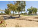 View from backyard overlooking desert landscaping and a pristine green golf course at 4843 E Ajo Cir, Phoenix, AZ 85044