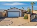 Charming single-story home featuring a two-car garage, well-maintained landscaping, and a driveway at 4932 W Golden Ln, Glendale, AZ 85302