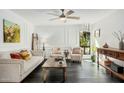 Bright living room features modern decor, a ceiling fan, and views of the greenery outside at 4950 N Miller Rd # 119, Scottsdale, AZ 85251