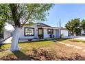 Single-story home with xeriscaped front yard and attached two-car garage in a neighborhood setting at 5223 W Lewis Ave, Phoenix, AZ 85035