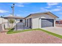 Attractive single-story home with a two-car garage, well-kept lawn, and a low-maintenance gravel front yard at 5942 W Seldon Ln, Glendale, AZ 85302