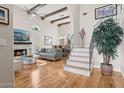 Bright and airy living room featuring hardwood floors, a fireplace, and a staircase with metal railing at 7504 N Via De La Siesta --, Scottsdale, AZ 85258