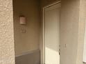 A close-up of the front door and doorbell on a light tan stucco home at 7887 N 16Th St # 227, Phoenix, AZ 85020