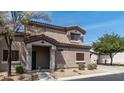 View of the front exterior of the home featuring desert landscaping and a covered porch at 8134 W Beck Ln, Peoria, AZ 85382