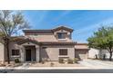 Front exterior of the house with low maintenance desert rock landscaping in front and a tile roof at 8134 W Beck Ln, Peoria, AZ 85382