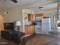 Bright kitchen with white appliances, wood cabinets, and a dining area with a round table at 8211 E Garfield St # J206, Scottsdale, AZ 85257