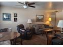 Inviting living room with a ceiling fan, a comfy sofa, and artwork displayed on the wall at 8211 E Garfield St # J206, Scottsdale, AZ 85257