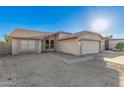 Attractive home with a neutral stucco exterior and a well-maintained, low-water front yard at 8709 W Roanoke Ave, Phoenix, AZ 85037