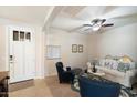 Cozy living room featuring tile floors, a ceiling fan, a front door, and comfortable seating at 9010 W Ruth Ave, Peoria, AZ 85345