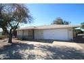 Ranch-style home featuring a two-car garage and a low-maintenance desert landscape at 9231 W Elkhorn Dr, Sun City, AZ 85351