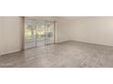 Inviting living room with tiled floors and sliding glass doors to let in natural light at 11047 N Coggins Dr, Sun City, AZ 85351