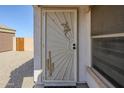 View of security screen door with southwestern themed decorative art at 1186 E Bradstock Way, San Tan Valley, AZ 85140