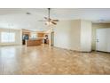 Open-concept living room with tiled floors leading into the kitchen area at 1186 E Bradstock Way, San Tan Valley, AZ 85140