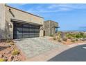 Modern desert home with a gray driveway, two-car garage and beautiful desert landscaping at 15921 E Ridgestone Dr, Fountain Hills, AZ 85268