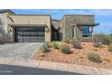 Beautiful desert home with a stone accent wall, lovely desert landscaping, and a 2 car garage at 15921 E Ridgestone Dr, Fountain Hills, AZ 85268