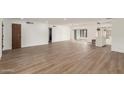 Spacious open-concept living room featuring wood-look flooring, and ample natural light at 1713 E Westchester Dr, Tempe, AZ 85283