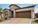 Stunning exterior view of the home with stone accents, a wide driveway, and a welcoming entrance at 1752 N Harper --, Mesa, AZ 85207