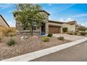 Attractive single-Gathering home featuring stone accents, a two-car garage, and desert-friendly landscaping at 1752 N Harper --, Mesa, AZ 85207