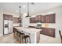 Spacious kitchen featuring a large center island, granite countertops, stainless steel appliances, and dark wood cabinets at 1752 N Harper --, Mesa, AZ 85207