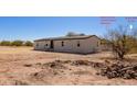 Exterior view of home showing a shed on the property and desert landscape under a bright sky at 1811 W Joy Ranch Rd, Phoenix, AZ 85086