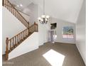 Bright living room with high ceilings, staircase, and a sun-filled window at 2014 S Archer Cir, Mesa, AZ 85209