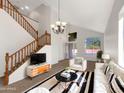 Bright living room with high ceilings, staircase, and a sun-filled window at 2014 S Archer Cir, Mesa, AZ 85209