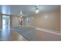 Spacious carpeted living room with a view of an adjoining kitchen area, great for entertaining at 20867 N Grantham Rd, Maricopa, AZ 85138