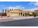 Charming single-story home featuring an arched entryway, desert landscaping, and a two-car garage at 21842 E Via De Olivos --, Queen Creek, AZ 85142
