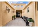 Welcoming front entrance with double doors, decorative lanterns, bench, and potted plants at 21842 E Via De Olivos --, Queen Creek, AZ 85142