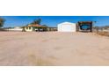 Property with a large lot, including a garage and covered parking for recreational vehicles at 22102 W Ripple Rd, Buckeye, AZ 85326