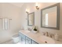 Stylish bathroom featuring double sinks, gray cabinets, white marble countertops, and modern fixtures at 40746 N Boone Ln, Anthem, AZ 85086