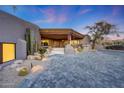 Desert home with a grand entrance, featuring unique architecture, native plants and a paver driveway at 40915 N 107Th Pl, Scottsdale, AZ 85262