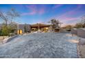 Desert home showcasing unique architecture and desert landscaping, with a spacious paver driveway at 40915 N 107Th Pl, Scottsdale, AZ 85262