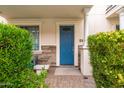 Charming blue front door with stone accents and lush landscaping at 4438 N 27Th St # 24, Phoenix, AZ 85016