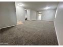 Large, carpeted living room featuring an open floor plan and ample space at 4669 E Sierrita Rd, San Tan Valley, AZ 85143