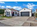 Beautiful single-story home featuring a spacious driveway, desert landscaping, and an attached garage at 5172 S Seton Ave, Gilbert, AZ 85298