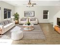 Bright living room boasts modern furnishings, neutral paint, and striped decor for a stylish space at 7009 W Lincoln St, Peoria, AZ 85345