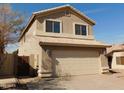 A two-story home with a neutral-colored facade and a two-car garage with tiled roof at 7830 S 26Th St, Phoenix, AZ 85042