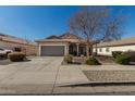 Charming single-story home featuring a two-car garage, covered porch, and low maintenance desert landscaping at 8734 S 57Th Dr, Laveen, AZ 85339