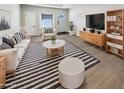 Bright living room with modern furnishings, stylish striped rug, and ample natural light, perfect for relaxation and entertainment at 9814 N Balboa Dr, Sun City, AZ 85351