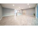 Spacious open-plan living room featuring new flooring, paint and lots of natural light at 10523 W Roundelay Cir, Sun City, AZ 85351