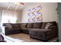 A cozy living room featuring a comfortable sectional couch under a vaulted ceiling at 11666 N 28Th Dr # 298, Phoenix, AZ 85029