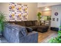 A comfortable grey couch resides in the living room, decorated with plants and Minnesota Vikings paraphernalia at 11666 N 28Th Dr # 298, Phoenix, AZ 85029