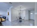 Well-lit dining space showcasing a decorative chandelier and tiled floors, perfect for gatherings at 11772 E Clinton St, Scottsdale, AZ 85259