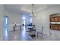 Bright dining area featuring tiled floors, modern lighting, and easy access to other rooms at 11772 E Clinton St, Scottsdale, AZ 85259