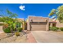 Charming single-story home with a two-car garage and low-maintenance desert landscaping at 11772 E Clinton St, Scottsdale, AZ 85259