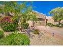 Inviting home with a well-maintained front yard, gravel, and a walkway leading to the front door at 11772 E Clinton St, Scottsdale, AZ 85259