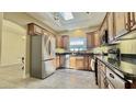 Well-lit kitchen features stainless steel appliances, granite countertops, and light-colored tile floors at 11772 E Clinton St, Scottsdale, AZ 85259